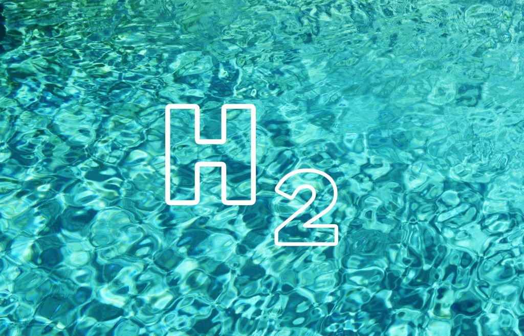 Turkoosia vettä, jonka päällä vedyn kemiallinen merkki.