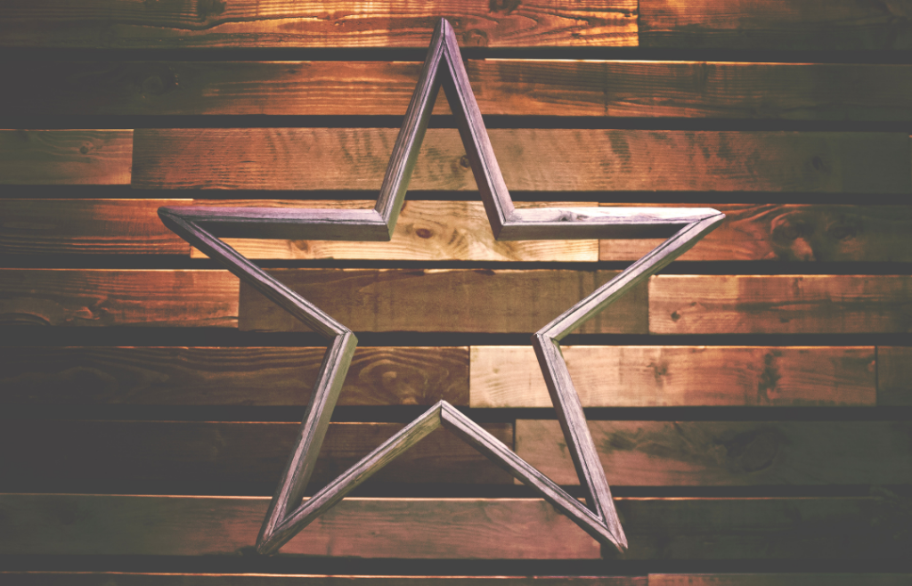 Star shaped ornament against wood wall.